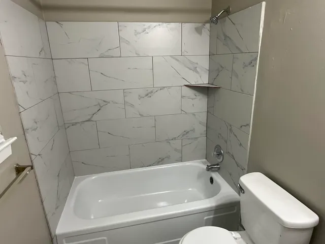 a bathroom with a toilet and bathtub