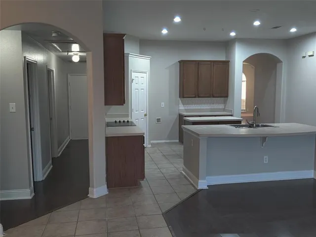 a kitchen with a refrigerator and a sink