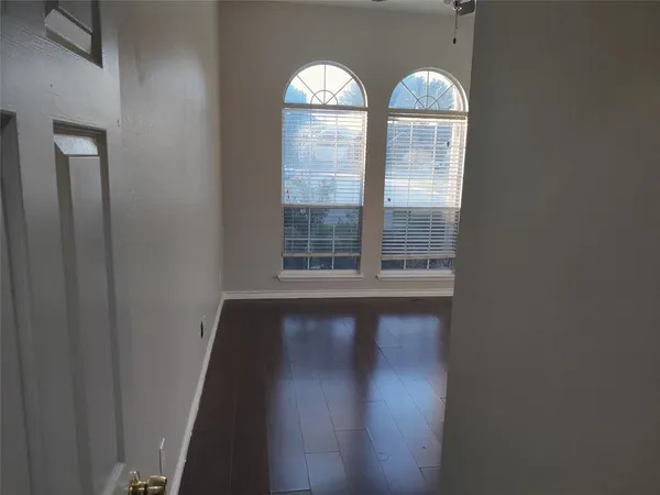 a view of wooden floor and windows in a room
