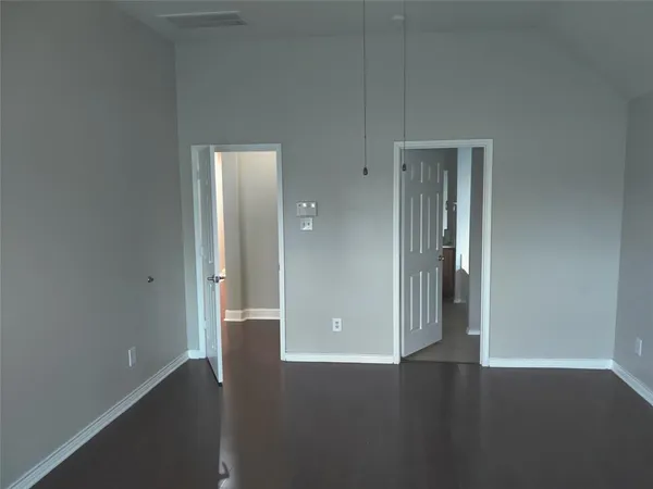 an empty room with wooden floor