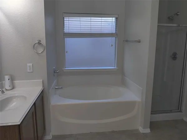 a white bath tub sitting next to a white sink