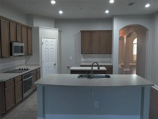 a kitchen with stainless steel appliances a sink and a stove