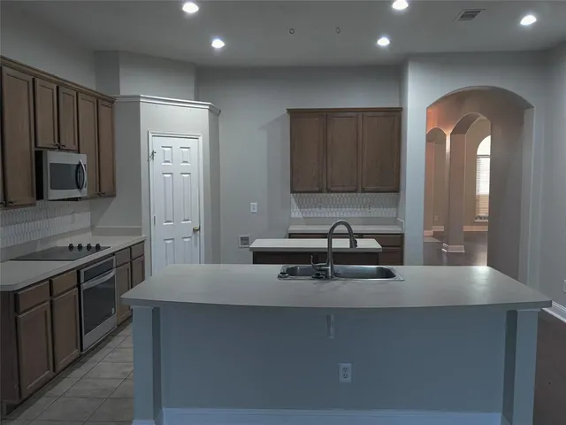 a kitchen with stainless steel appliances a sink and a stove