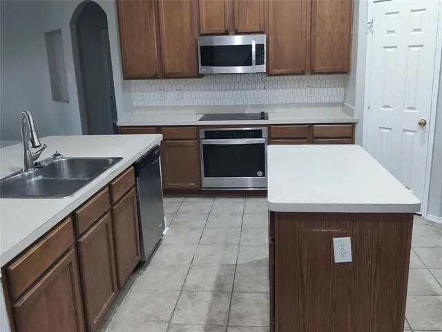 a kitchen with a sink and a microwave