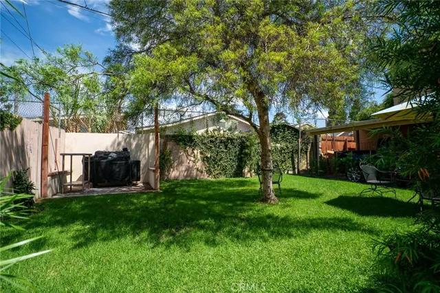 a garden with trees in front of it