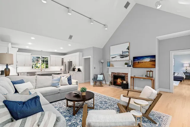 a living room with furniture fireplace and dining table