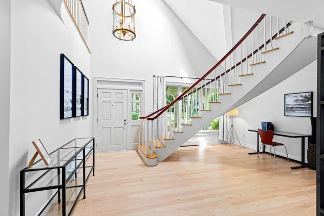 a view of entryway and hall with wooden floor