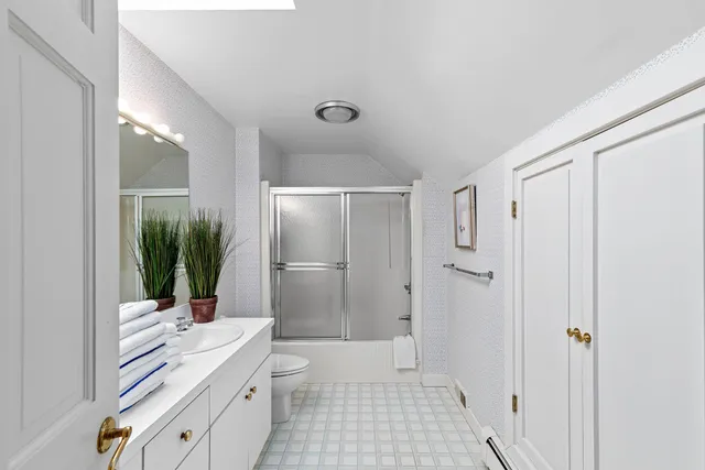 a bathroom with a double vanity sink toilet and shower