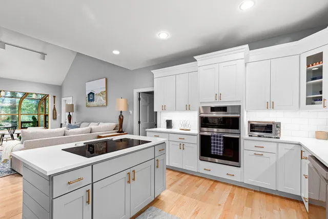 a kitchen that has a sink and a stove in it