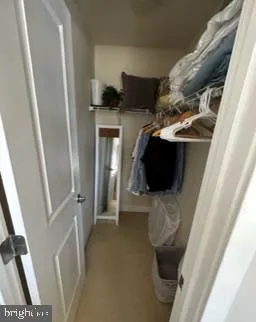 a bedroom with a bed window and dresser