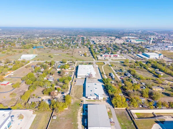 a view of a house with a yard covered in the forest