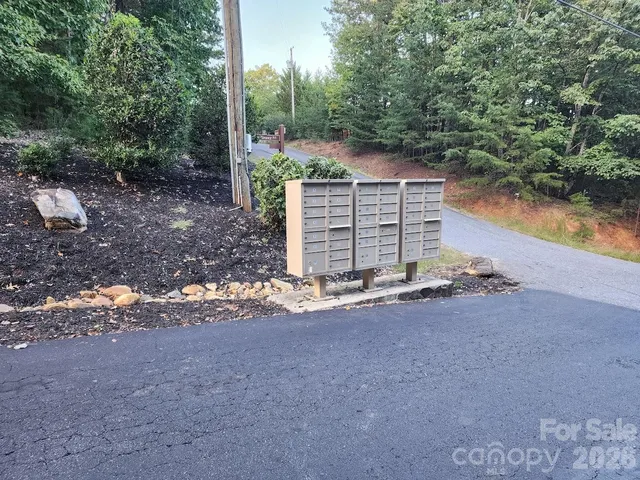 a view of a house with a yard and lake view