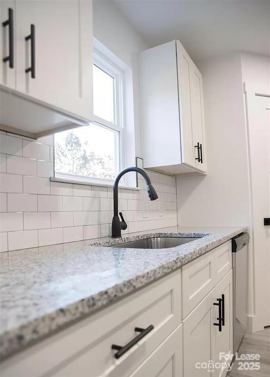 603 Edna Graves Way, Unit A Cherryville, NC 28021 - Photo 5 of 20 a kitchen with granite countertop white cabinets and a window
