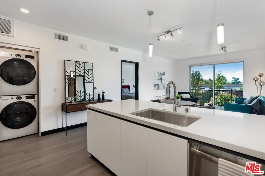 11036 Moorpark Street, Unit PH18 Los Angeles, CA 91602 - Photo 11 of 22 a view of a kitchen with a sink dishwasher a washer and dryer