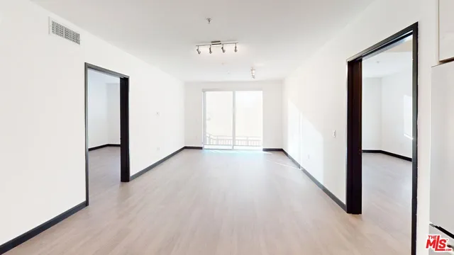 a view of a hallway with wooden floor