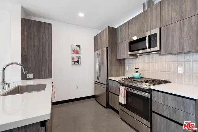 a living room with furniture floor to ceiling window and a flat screen tv