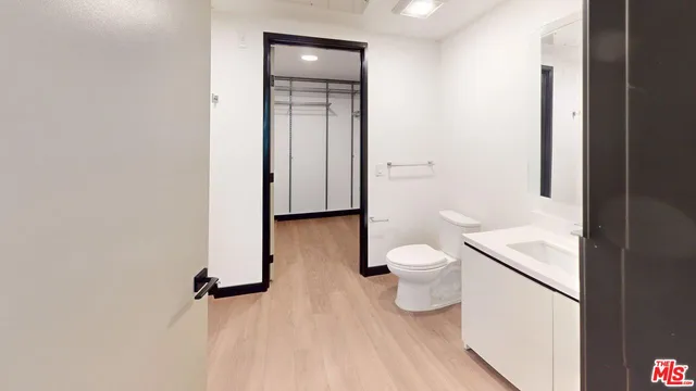 a bathroom with a granite countertop toilet and a sink