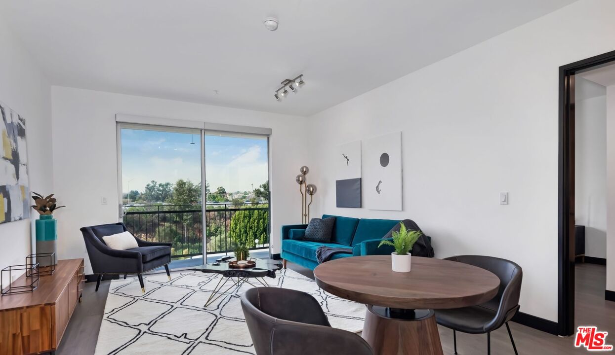 11036 Moorpark Street, Unit PH18 Los Angeles, CA 91602 - Photo 6 of 22 a living room with furniture a table and a potted plant