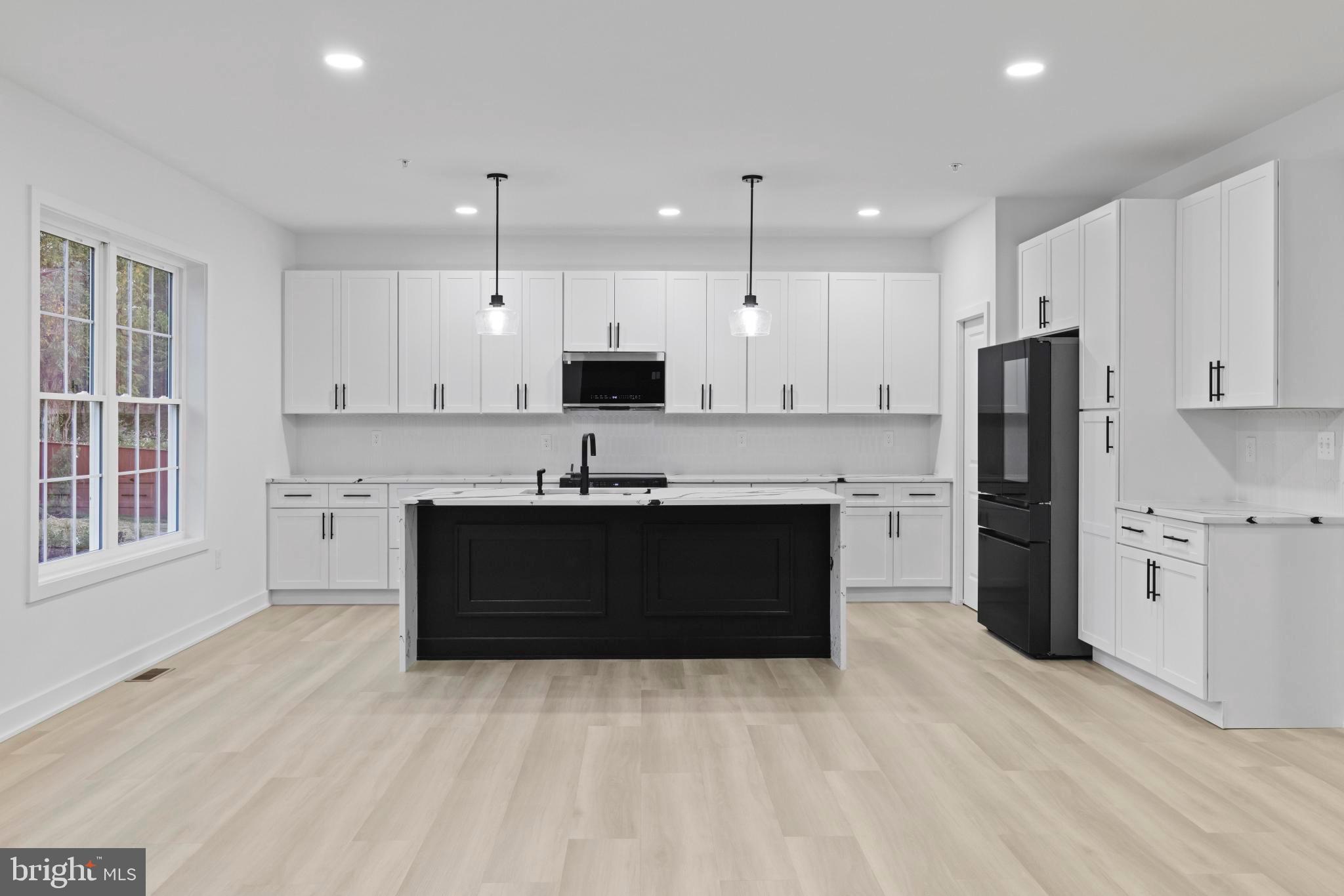 235 Brock Bridge Road Laurel, MD 20724 - Photo 15 of 59 a kitchen with a refrigerator sink and cabinets