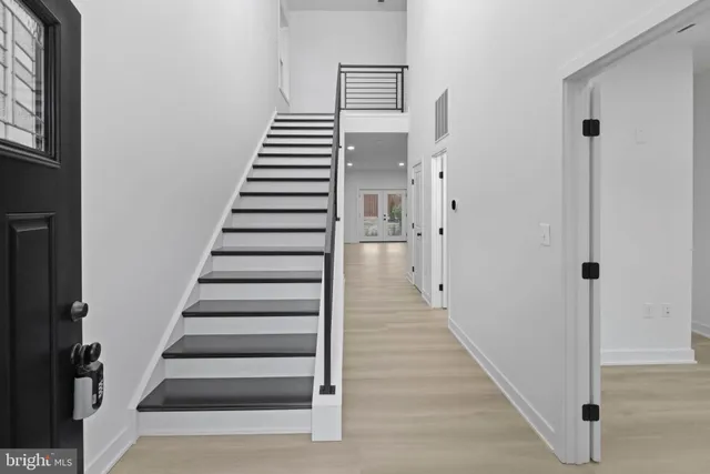 a large kitchen with granite countertop a stove and a sink dishwasher with wooden floor