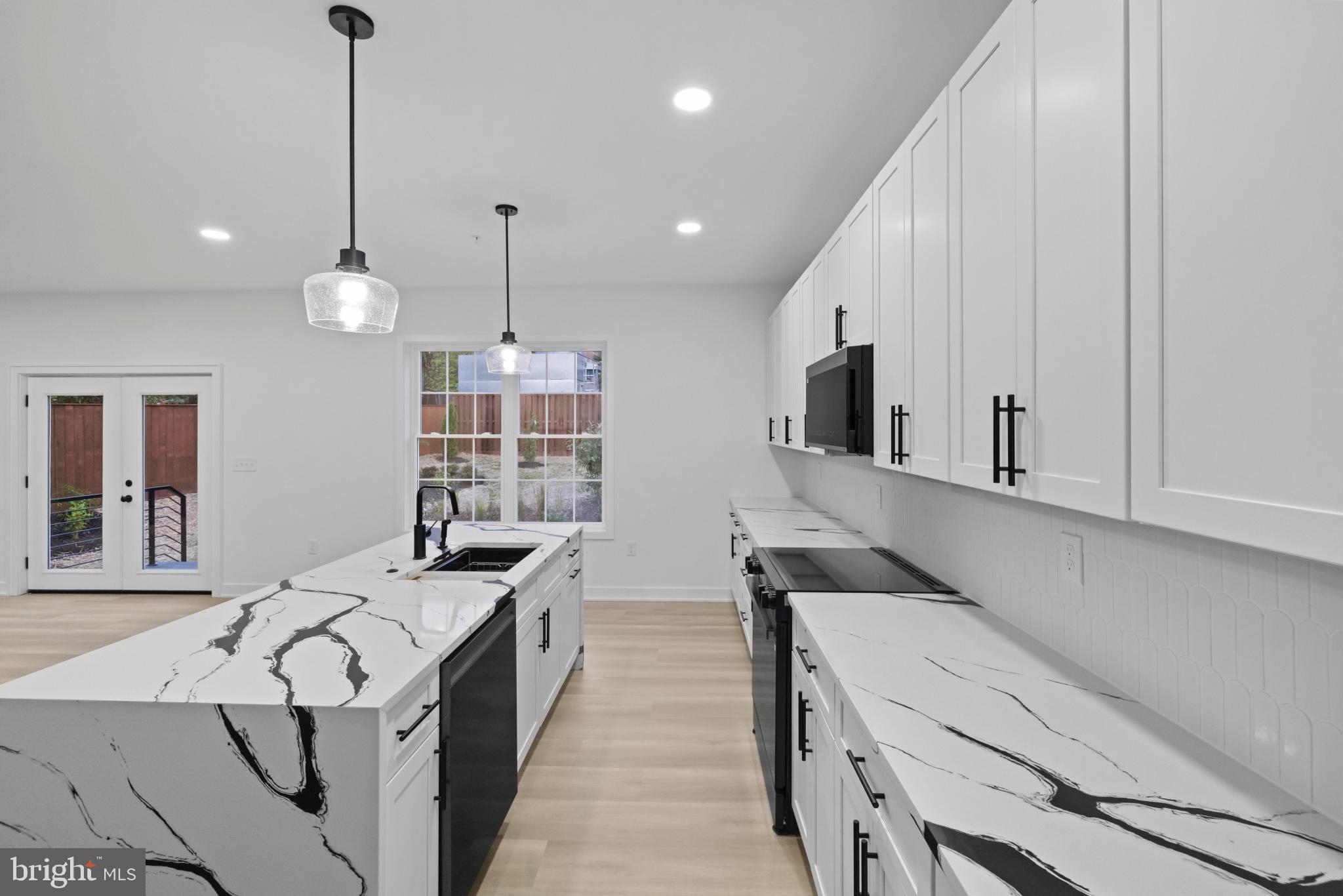 235 Brock Bridge Road Laurel, MD 20724 - Photo 19 of 59 a kitchen with a sink stove and microwave
