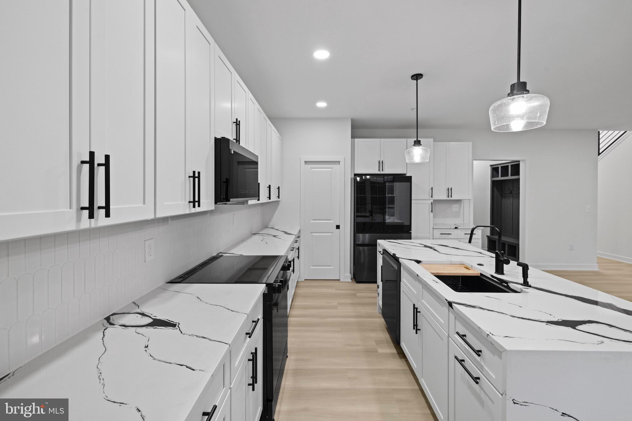 235 Brock Bridge Road Laurel, MD 20724 - Photo 20 of 59 a large kitchen with granite countertop a stove and a sink dishwasher with wooden floor
