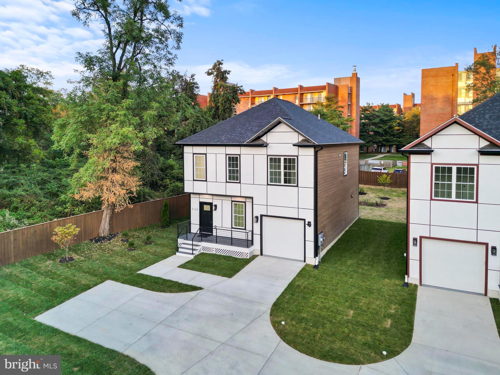 235 Brock Bridge Road Laurel, MD 20724 - Photo 2 of 59 a view of a white house with a small yard and plants