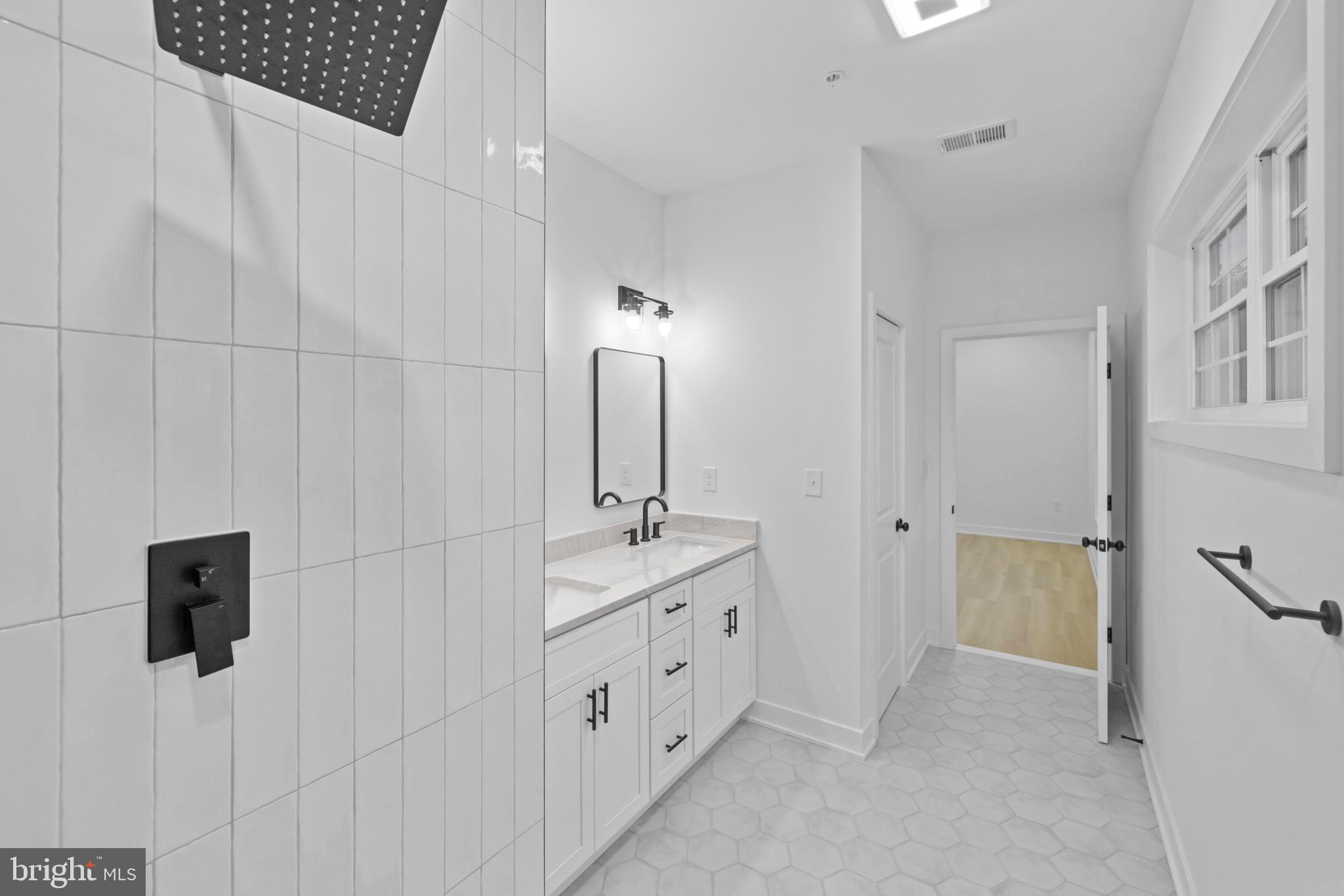 235 Brock Bridge Road Laurel, MD 20724 - Photo 29 of 59 a spacious bathroom with a double vanity sink a toilet a mirror and shower