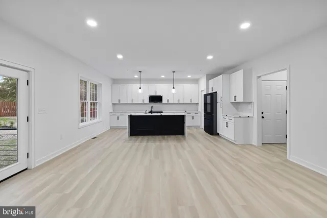 a large kitchen with kitchen island a sink dishwasher stove and refrigerator