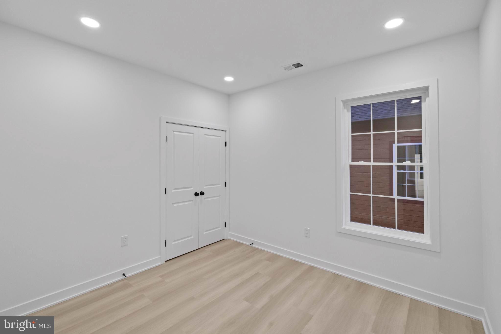 235 Brock Bridge Road Laurel, MD 20724 - Photo 32 of 59 an empty room with wooden floor and windows