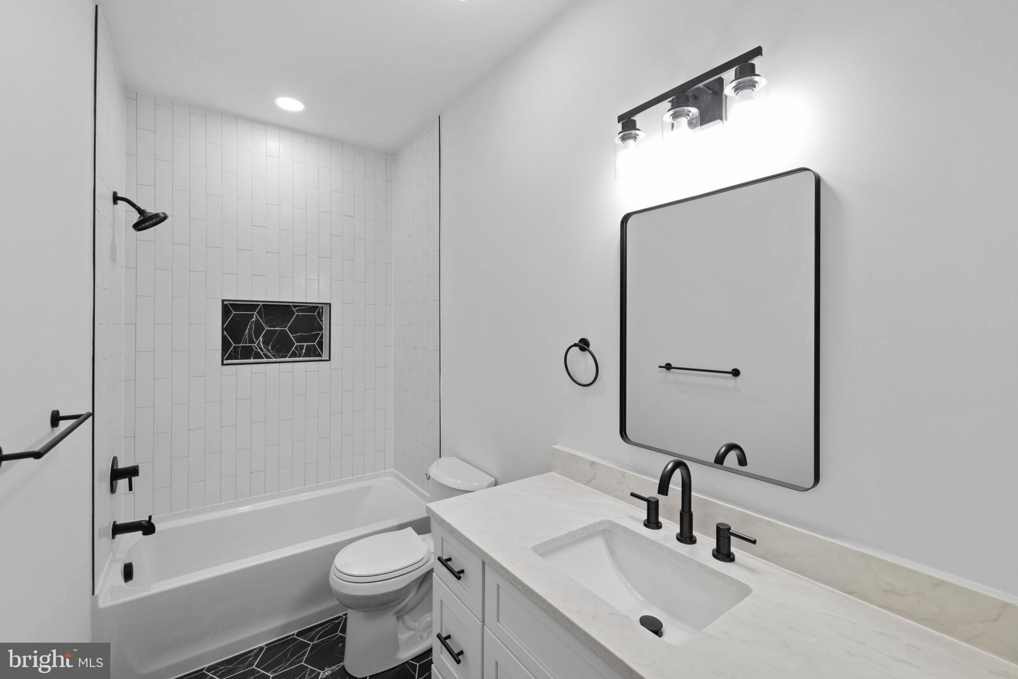 235 Brock Bridge Road Laurel, MD 20724 - Photo 34 of 59 a bathroom with a sink a toilet and shower