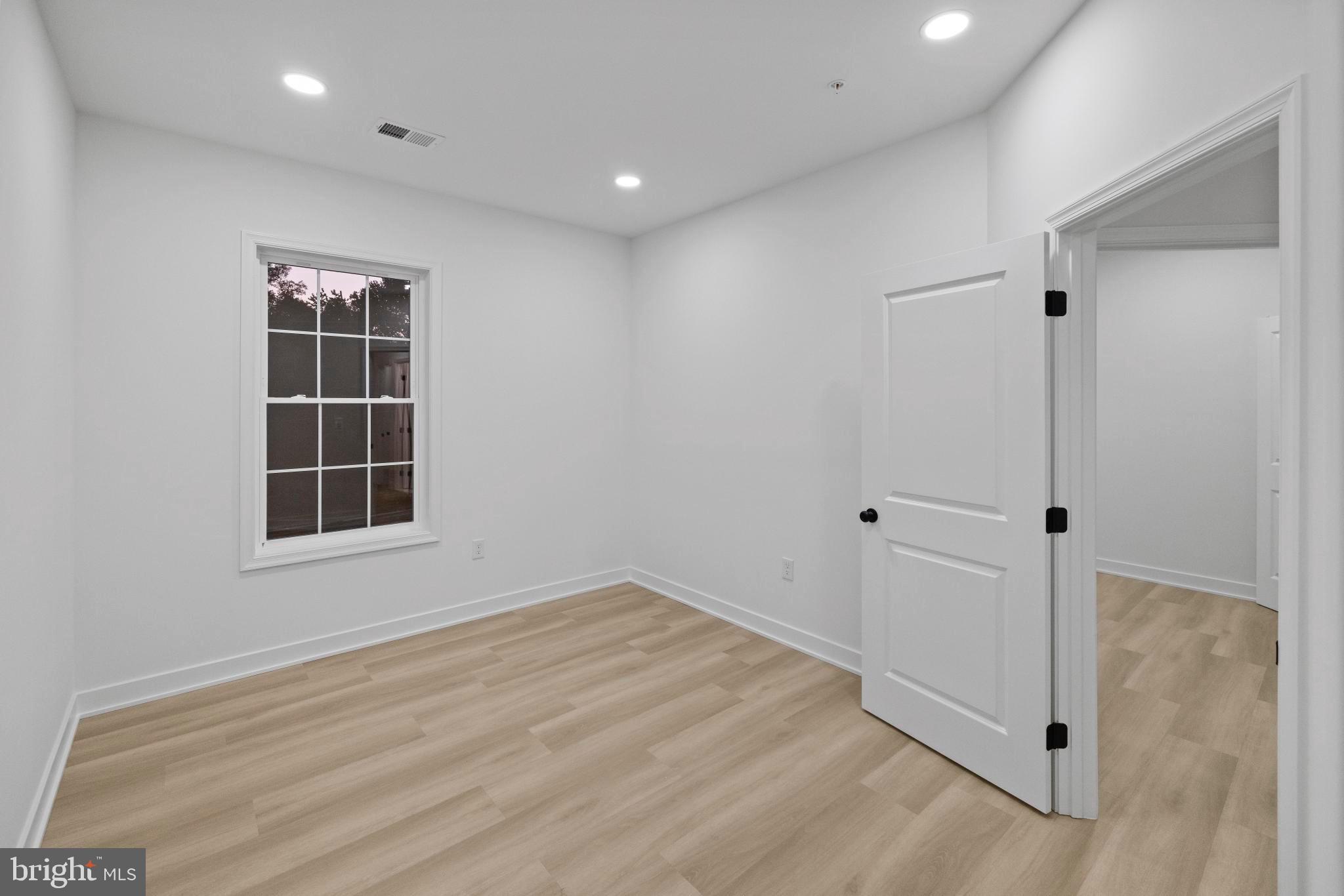 235 Brock Bridge Road Laurel, MD 20724 - Photo 46 of 59 an empty room with wooden floor and windows