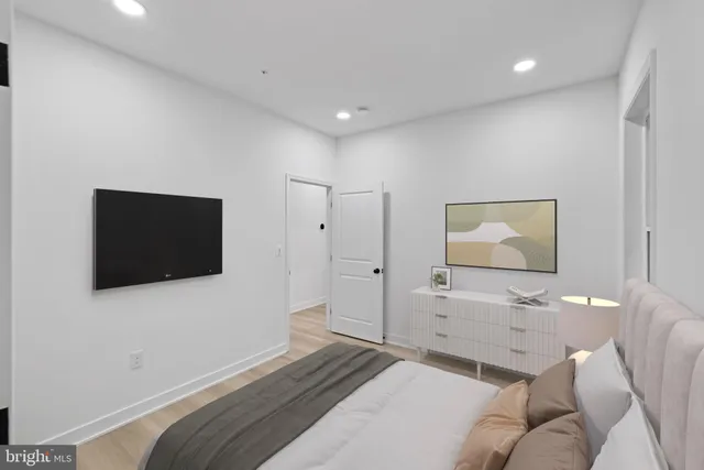 a bedroom with a bed and a flat screen tv