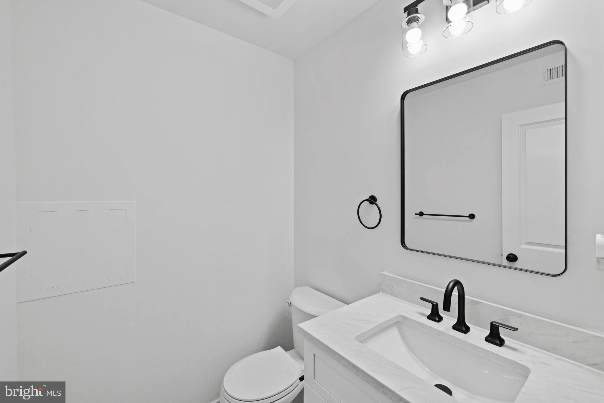 235 Brock Bridge Road Laurel, MD 20724 - Photo 51 of 59 a bathroom with a sink toilet and mirror