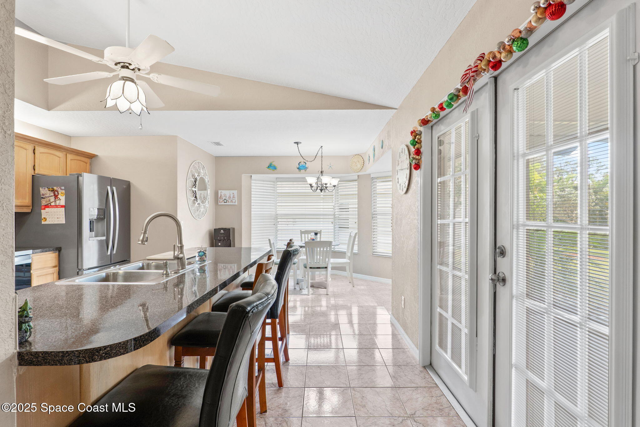 441 Southwest Avocado Avenue Sebastian, FL 32958 - Photo 12 of 30 a dining table chair next to a window with a chandelier