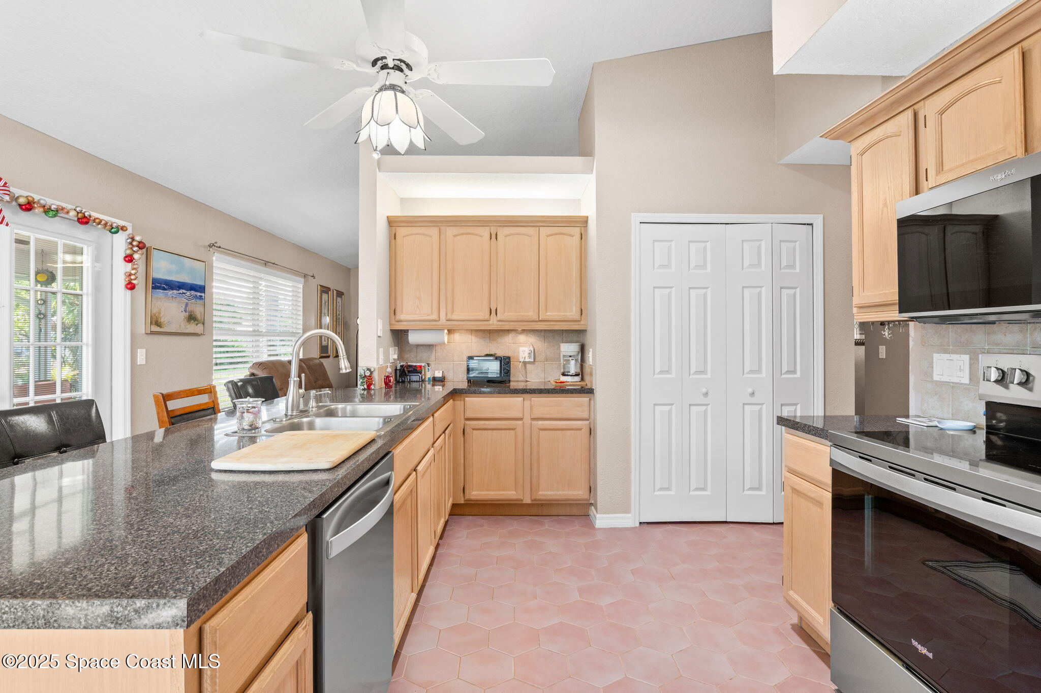 441 Southwest Avocado Avenue Sebastian, FL 32958 - Photo 14 of 30 a kitchen with granite countertop a sink a counter top space appliances and cabinets