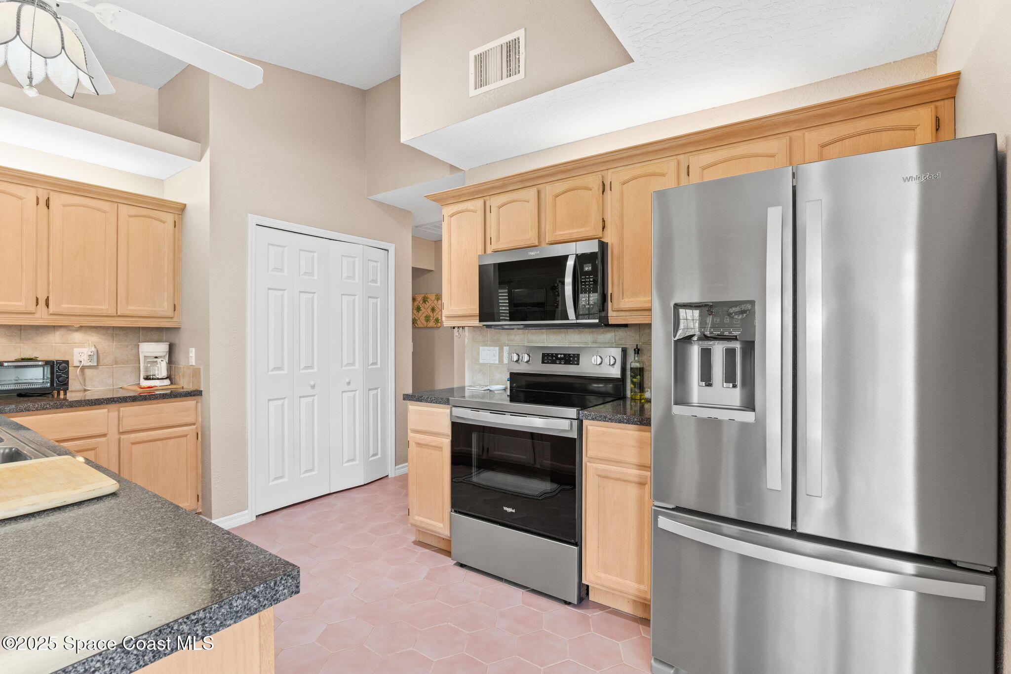 441 Southwest Avocado Avenue Sebastian, FL 32958 - Photo 15 of 30 a kitchen with stainless steel appliances granite countertop a refrigerator a stove top oven a sink and dishwasher