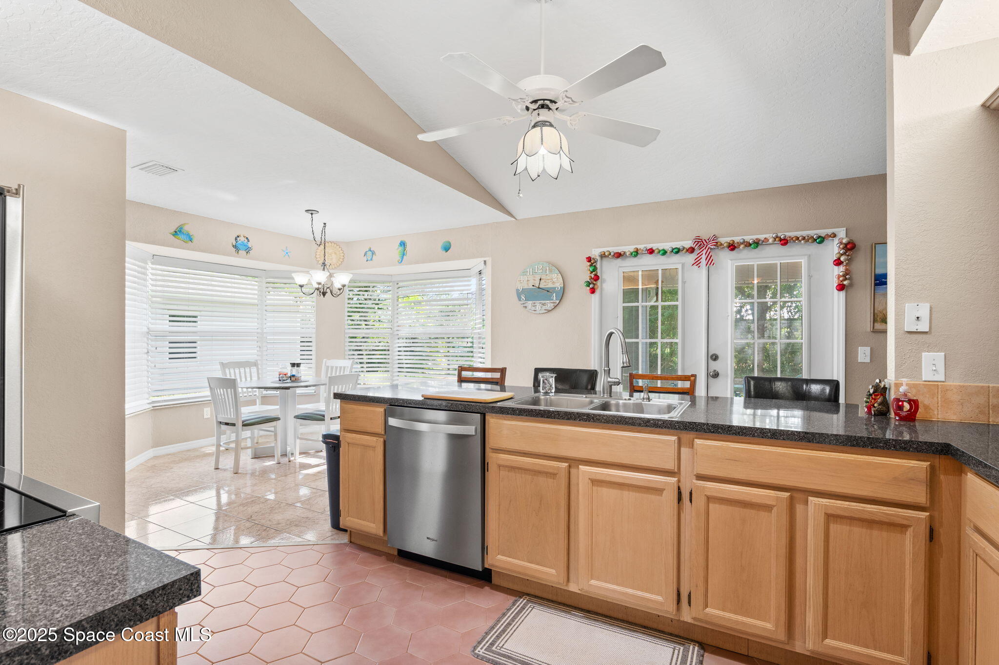 441 Southwest Avocado Avenue Sebastian, FL 32958 - Photo 16 of 30 a kitchen with stainless steel appliances granite countertop a sink and cabinets