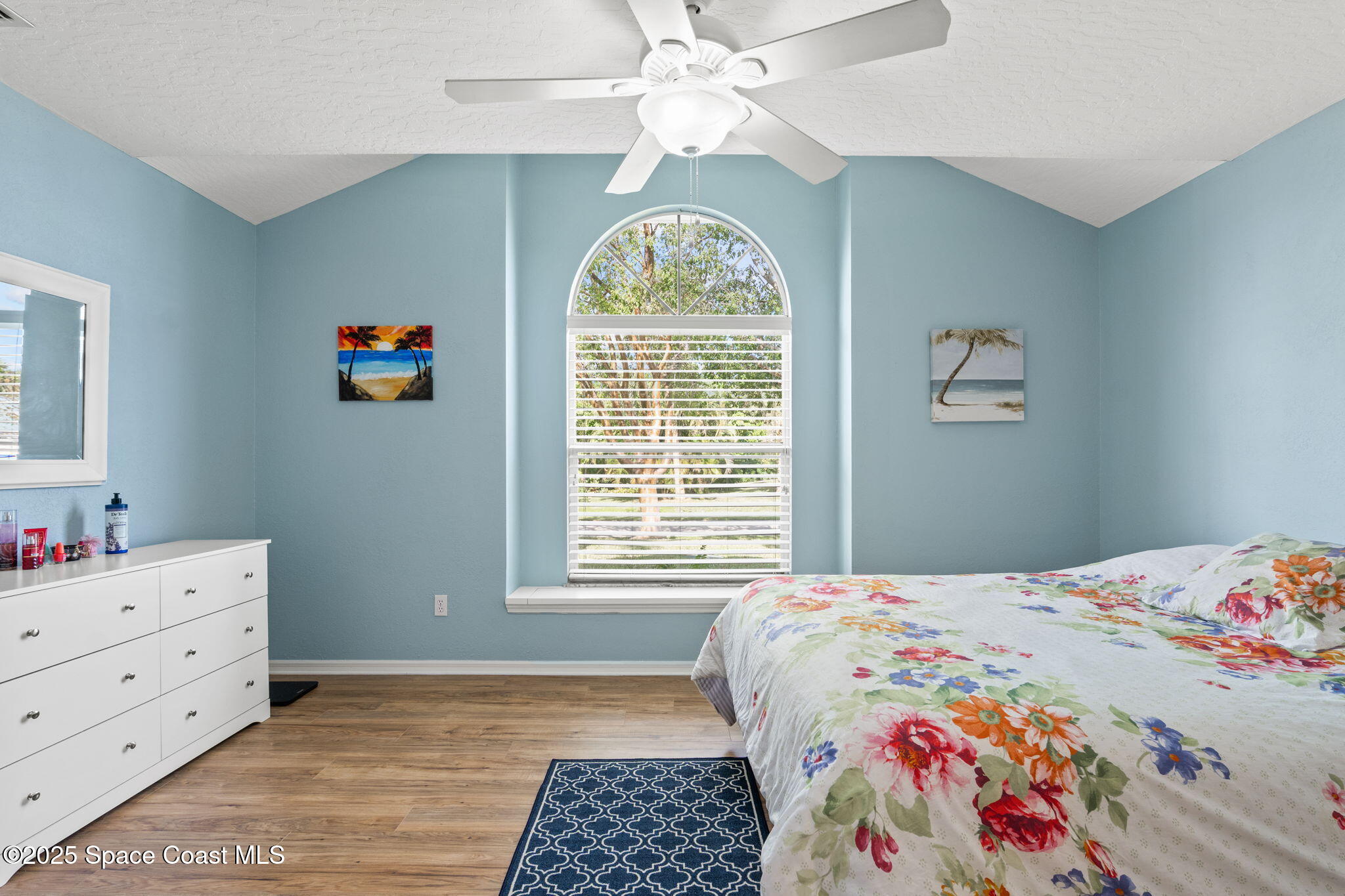 441 Southwest Avocado Avenue Sebastian, FL 32958 - Photo 20 of 30 a bedroom with a bed and a chandelier