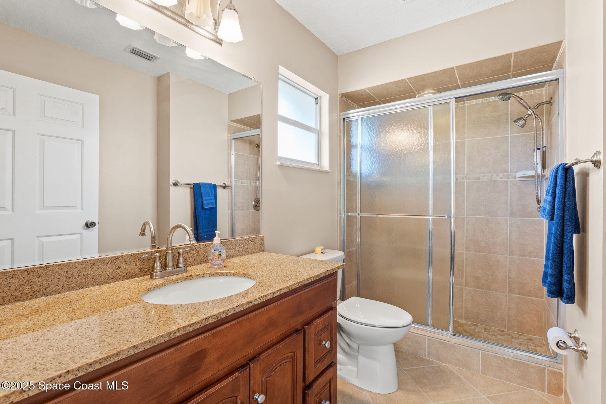 441 Southwest Avocado Avenue Sebastian, FL 32958 - Photo 22 of 30 a bathroom with a granite countertop sink toilet and shower