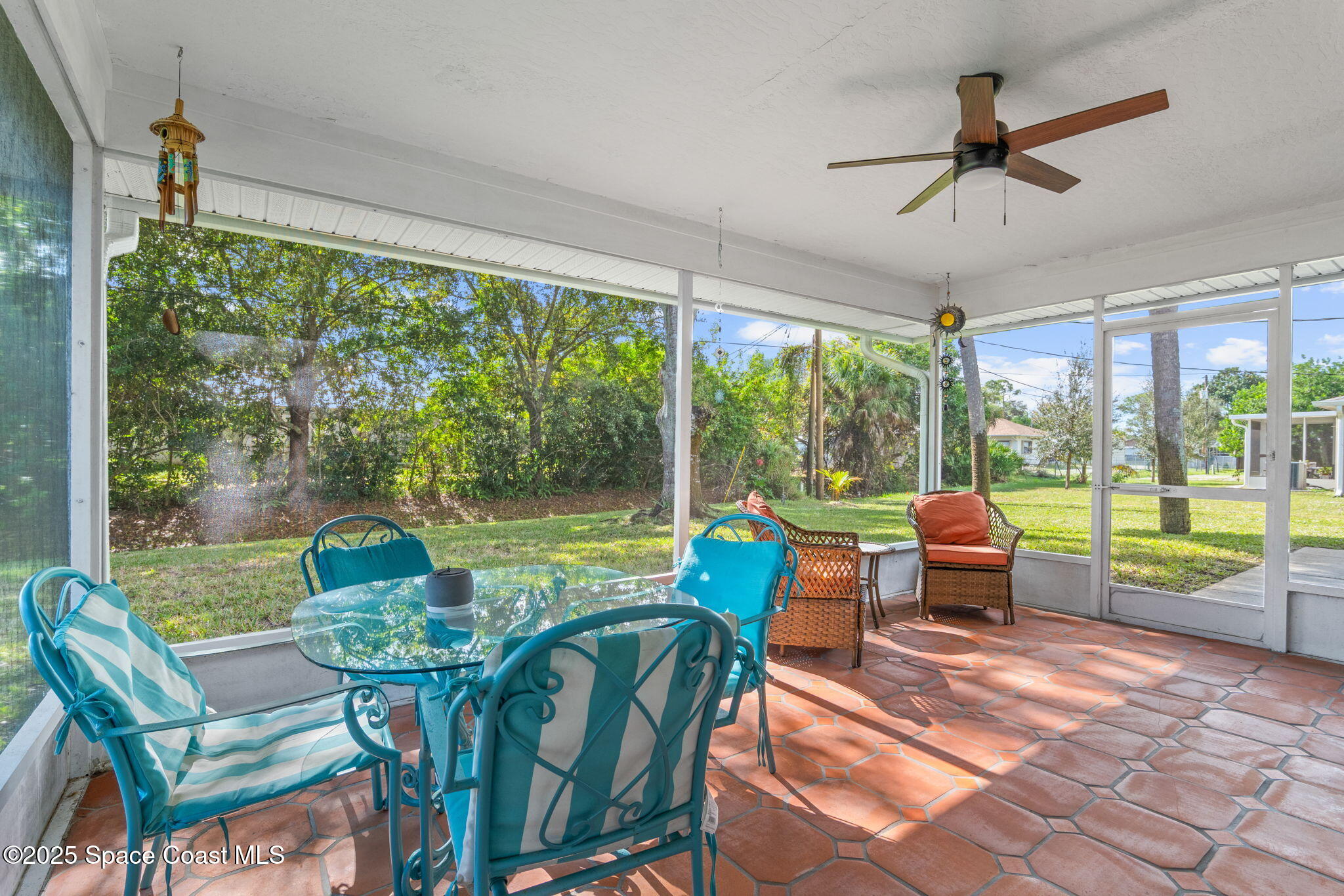 441 Southwest Avocado Avenue Sebastian, FL 32958 - Photo 23 of 30 a dining room with furniture a fireplace and a floor to ceiling window