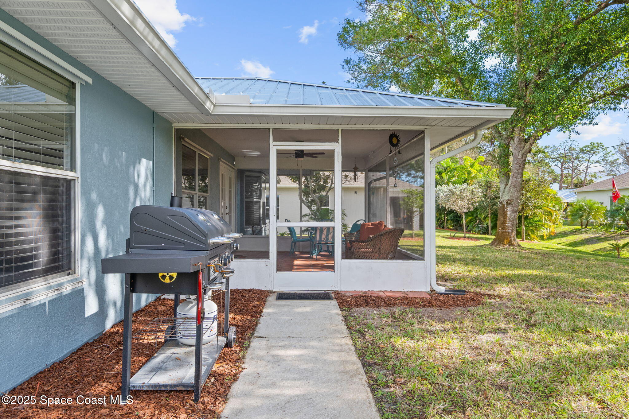 441 Southwest Avocado Avenue Sebastian, FL 32958 - Photo 24 of 30 a front view of a house with sitting area and garden