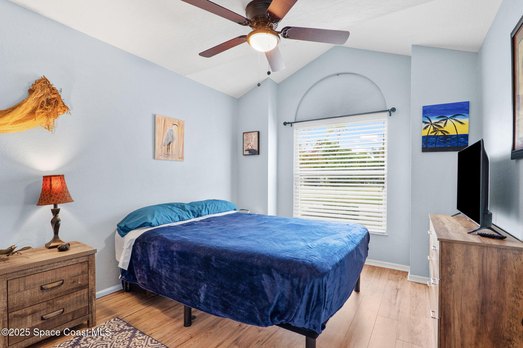 441 Southwest Avocado Avenue Sebastian, FL 32958 - Photo 6 of 30 a bedroom with a bed and a chandelier