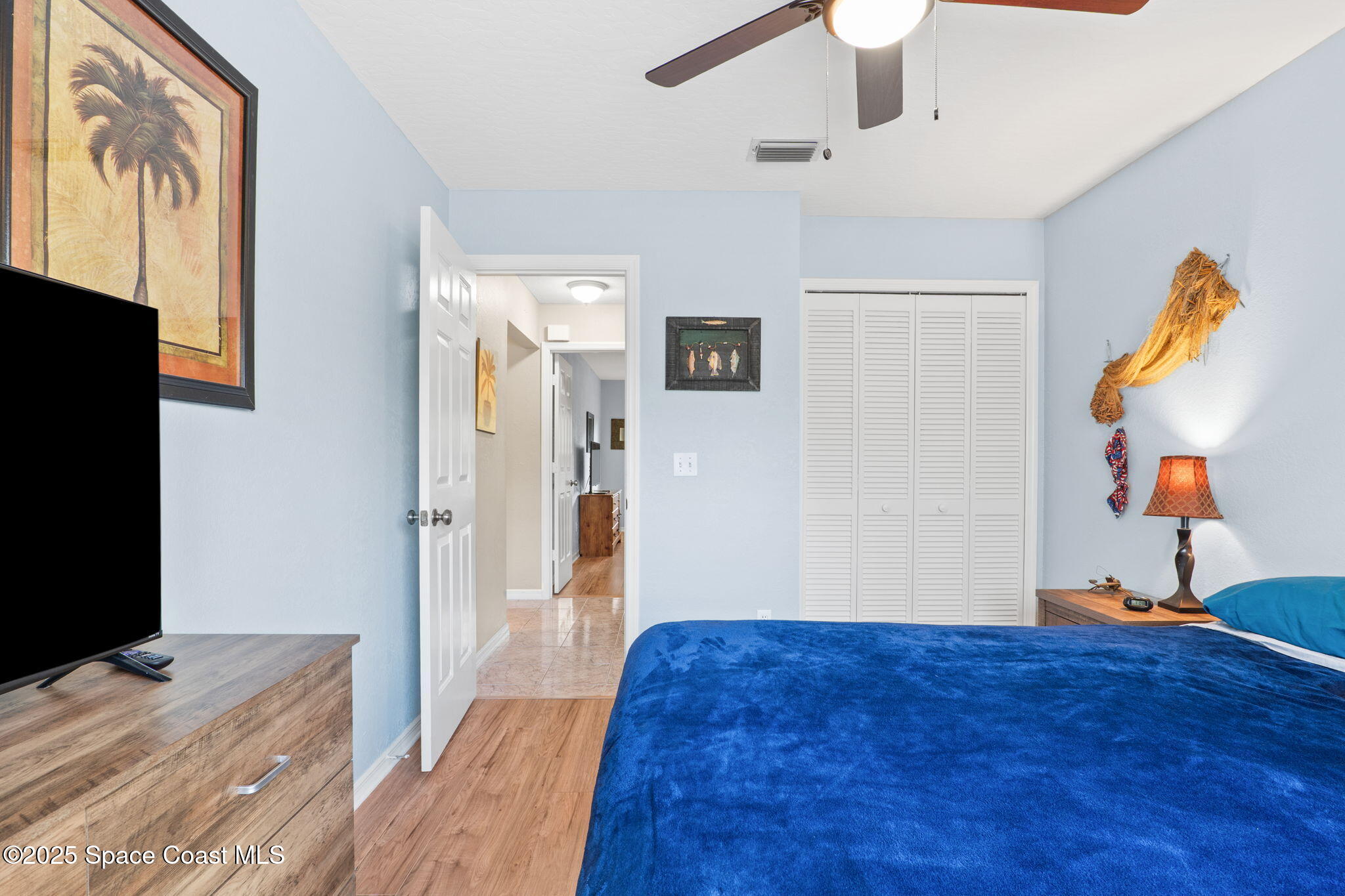 441 Southwest Avocado Avenue Sebastian, FL 32958 - Photo 7 of 30 a bedroom with a bed and a flat screen tv