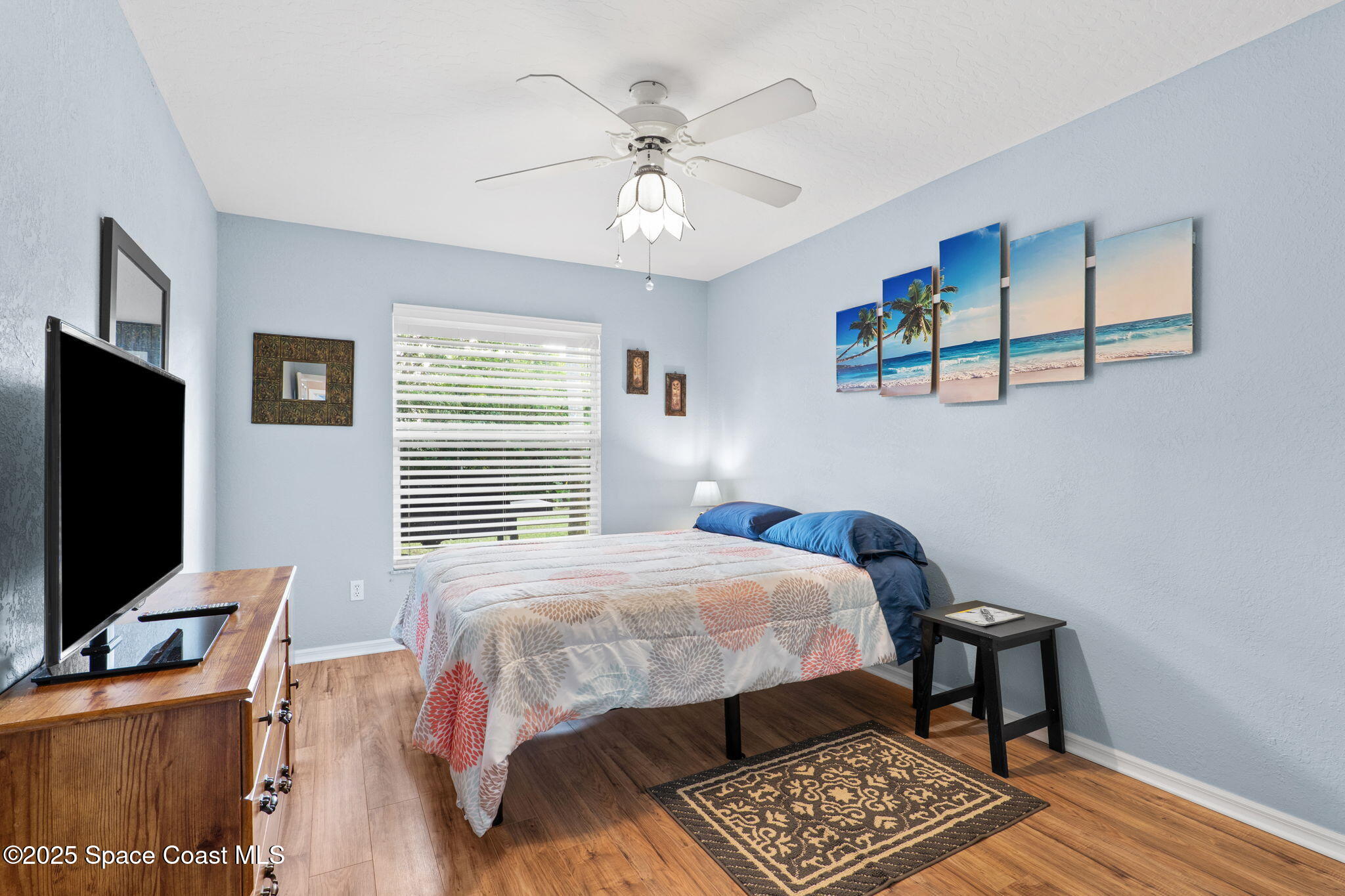 441 Southwest Avocado Avenue Sebastian, FL 32958 - Photo 8 of 30 a bedroom with a bed and a flat screen tv