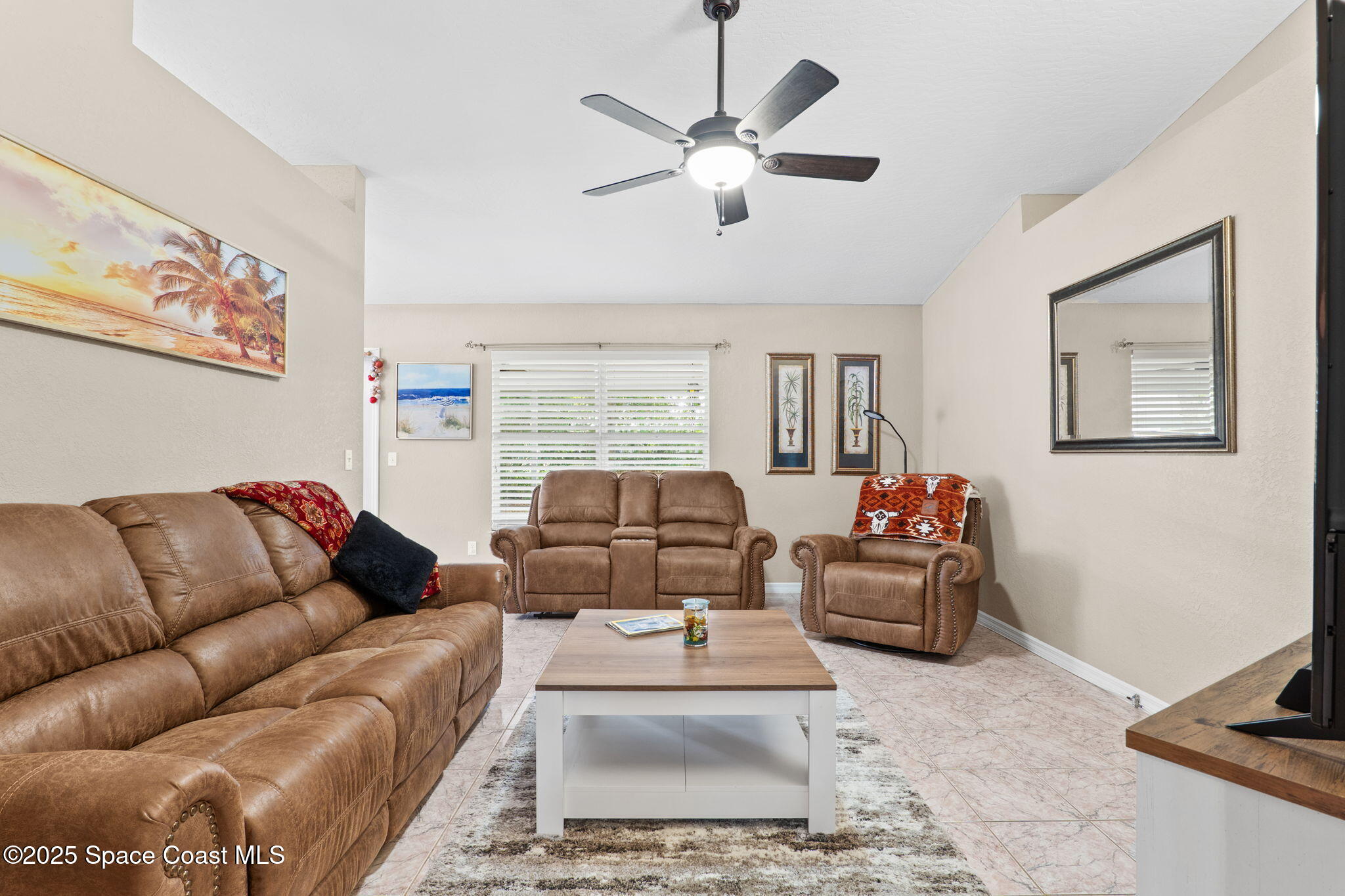 441 Southwest Avocado Avenue Sebastian, FL 32958 - Photo 10 of 30 a living room with furniture ceiling fan and a window