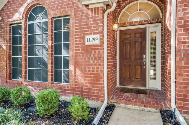 a view of a brick house with a large windows