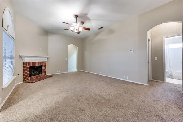 en view of an empty room with a fireplace