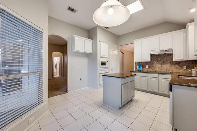 a kitchen with stainless steel appliances granite countertop a sink and cabinets