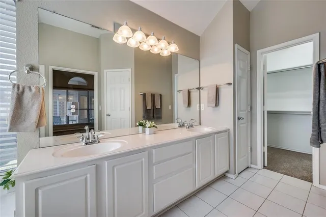 a bathroom with a double vanity sink and a mirror